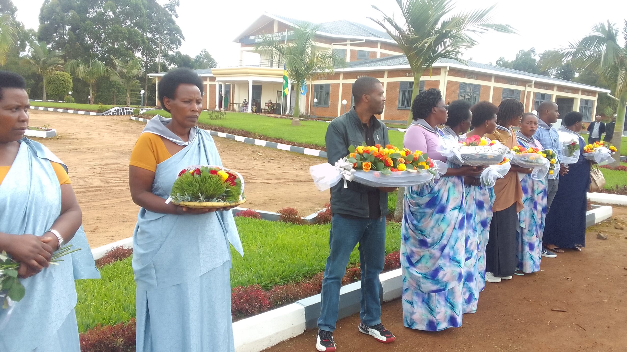 The person of SOHEDEO (3rd persons from left) ready to lay flowers on the tomb of victims of genocide resting at GASHIRABWOBA genocide memorial site.